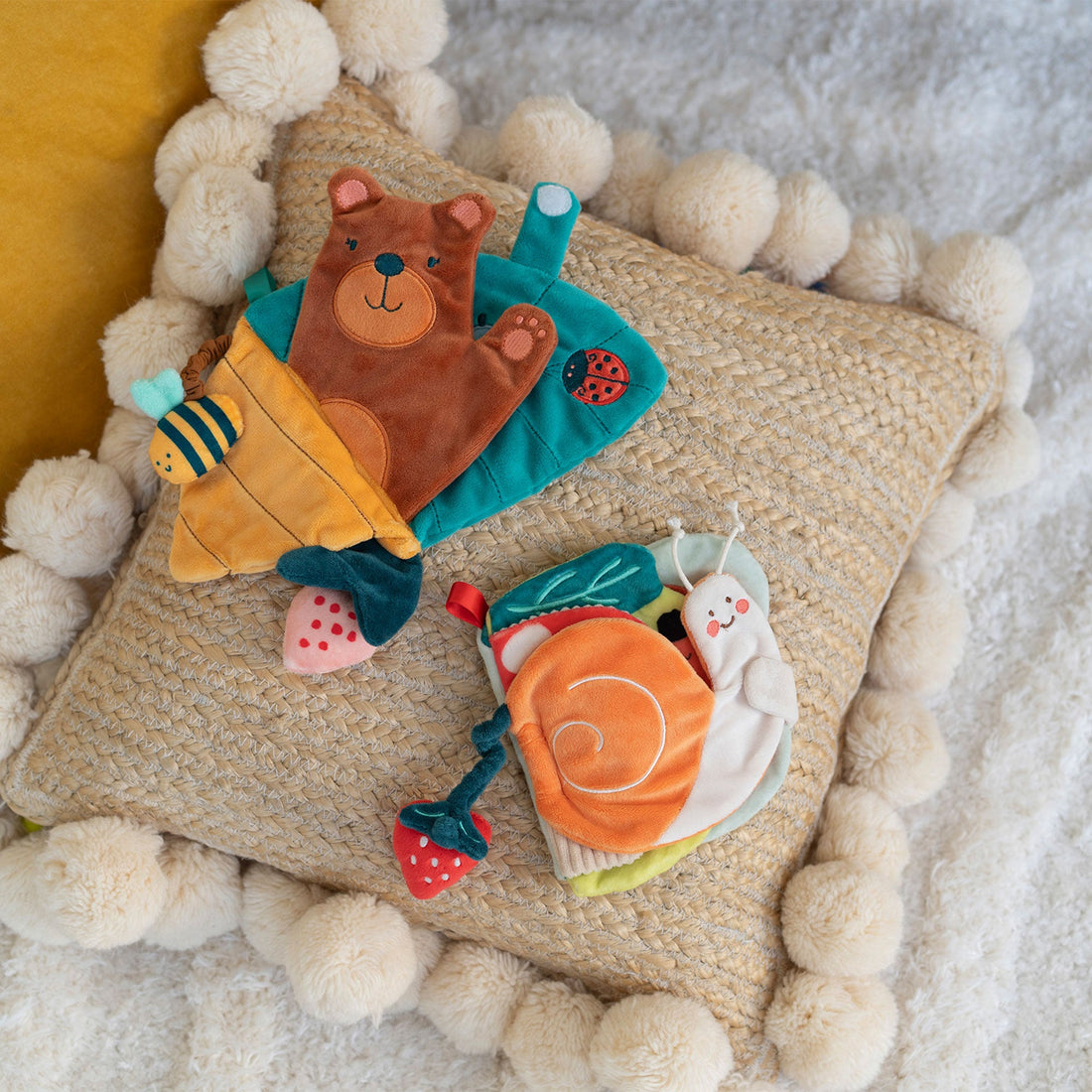 Manhattan Toy Silly Snail Sensory Book - Silly Snail book displayed with another soft book