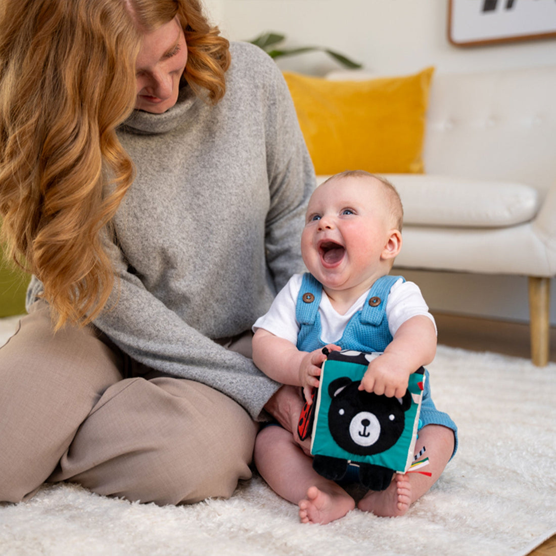 Manhattan Toy Wimmer Discovery Cube - baby holding the bear side with a parent