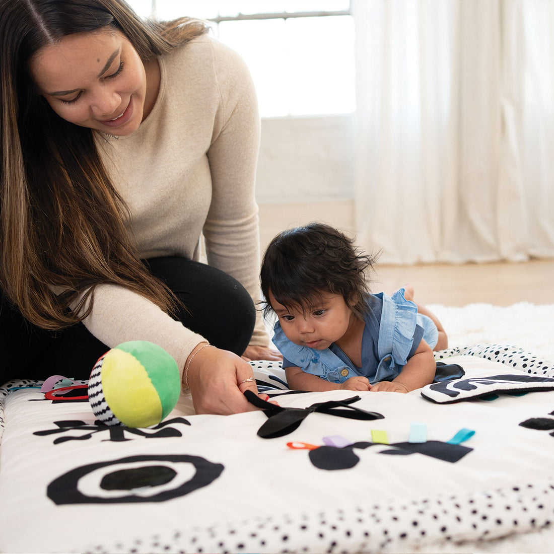 Manhattan Toy Wimmer Seek & Explore Mat - parent and baby exploring the sensory ball