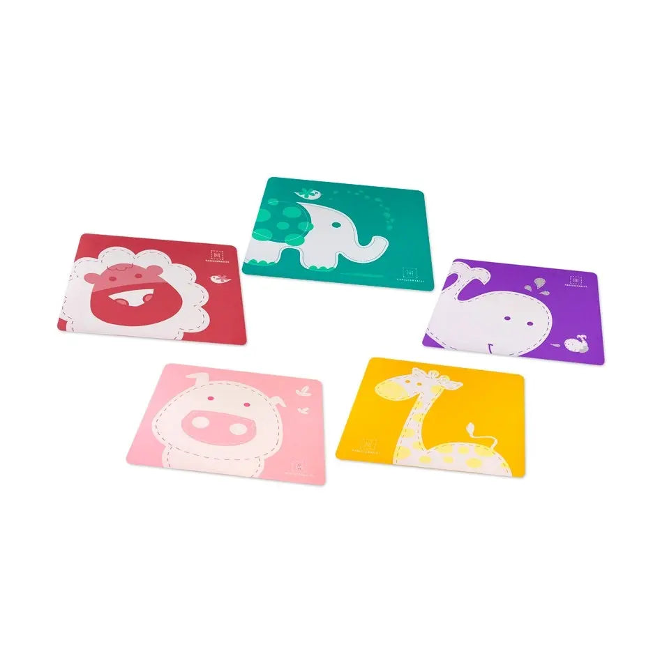 Marcus & Marcus baby placemat set of five in bright animal designs laid out for mealtime.