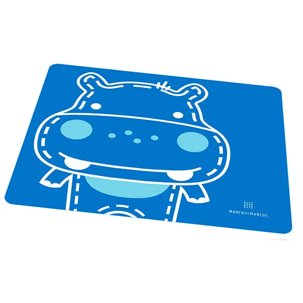 Marcus & Marcus Baby Placemat, blue rectangular mat laid flat on a table with a cheerful hippo mascot.