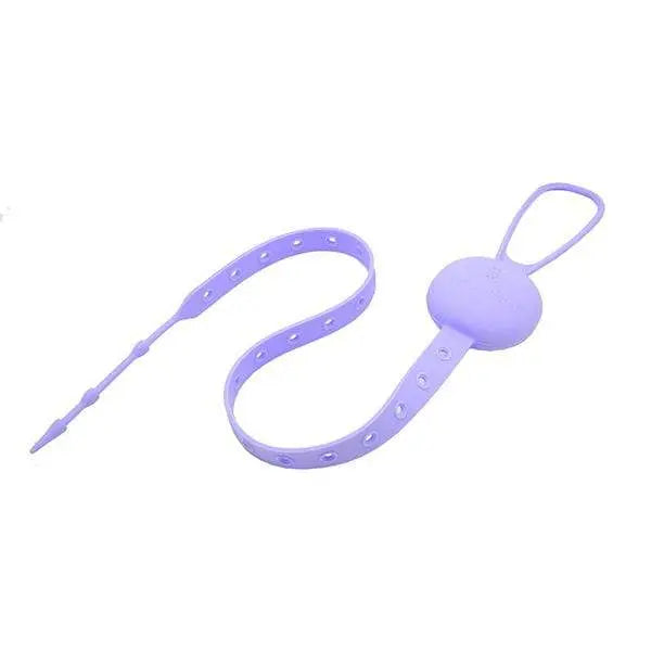 Marcus & Marcus Flip N' Strap lavender silicone feeding strap with clip securing a baby feeding spoon.