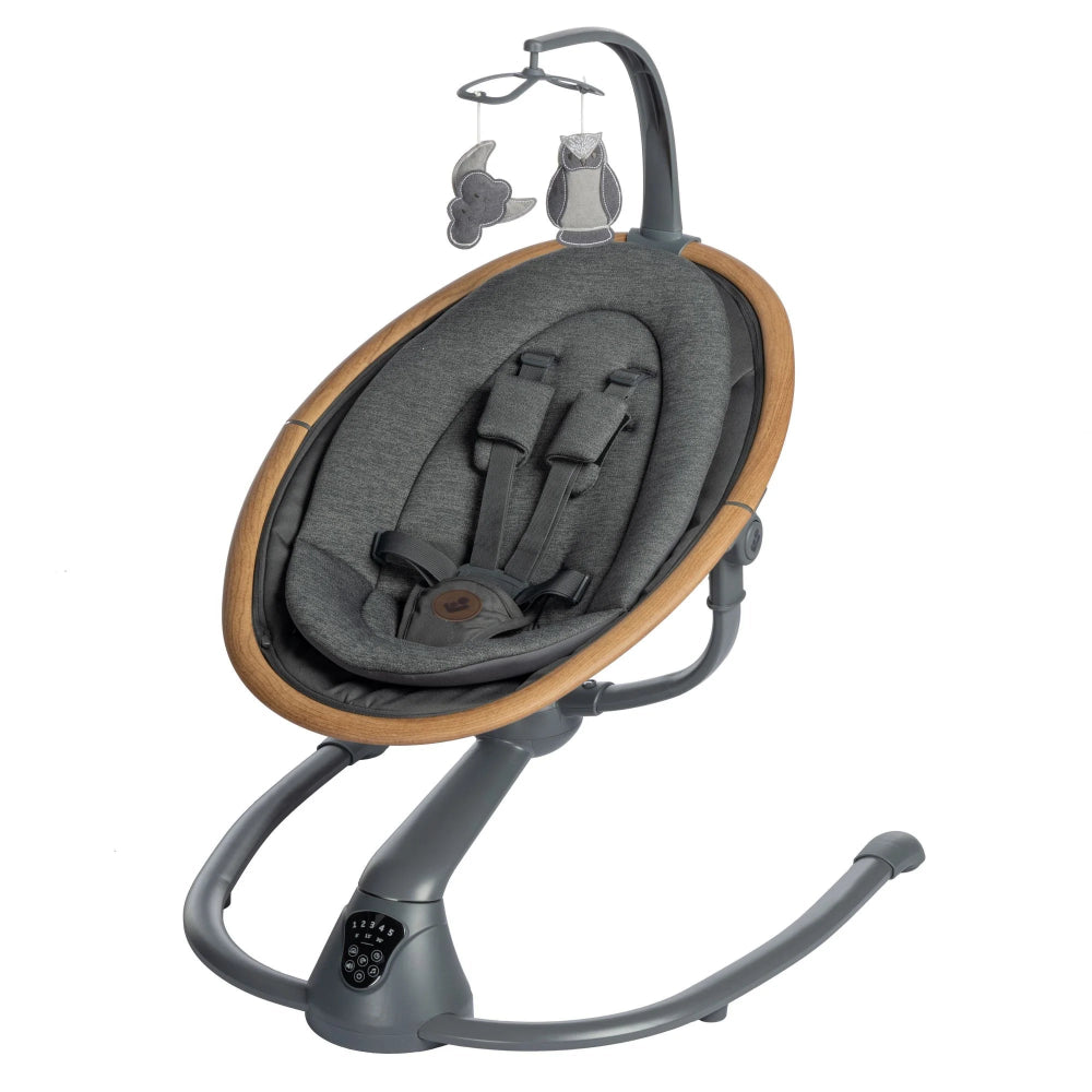 Maxi-Cosi Cassia Swing in gray cushioned seat with wood ring frame, gently swaying with hanging toys.