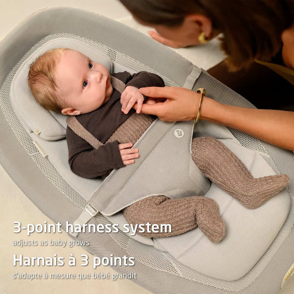 Gray mesh baby bouncer with gold frame and side adjustment button