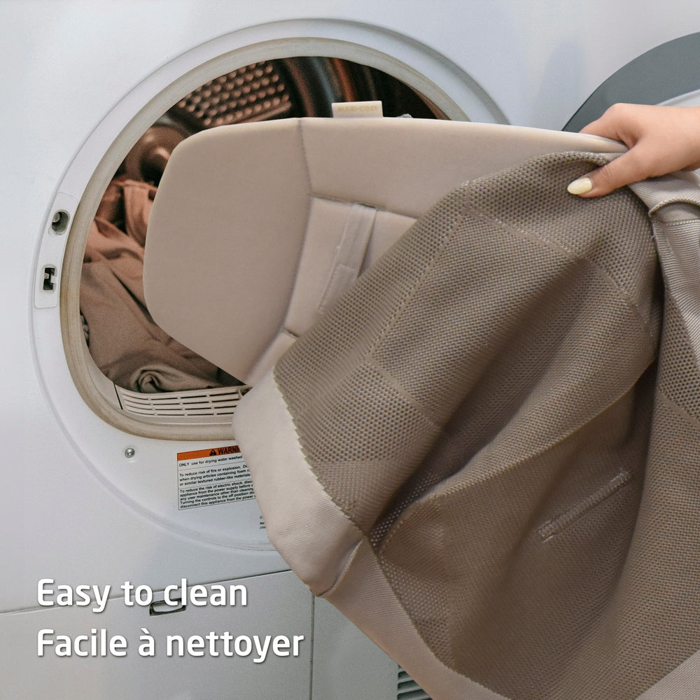 Beige baby bouncer seat cover in a front-load dryer