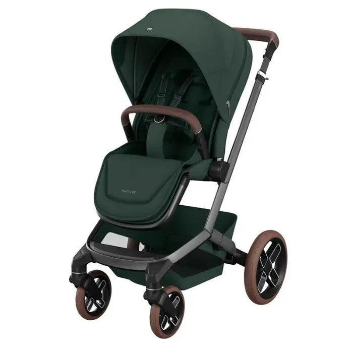 Maxi-Cosi Fame stroller in dark green with brown handles and wheels, shown ready for a stroll.