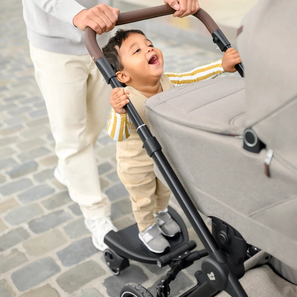 Maxi-Cosi Hop-on Board stroller accessory in black frame with brown handlebar grip for toddler boarding
