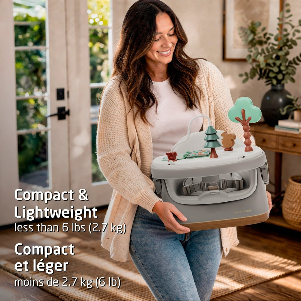 Woman holding a compact baby walker in a home setting