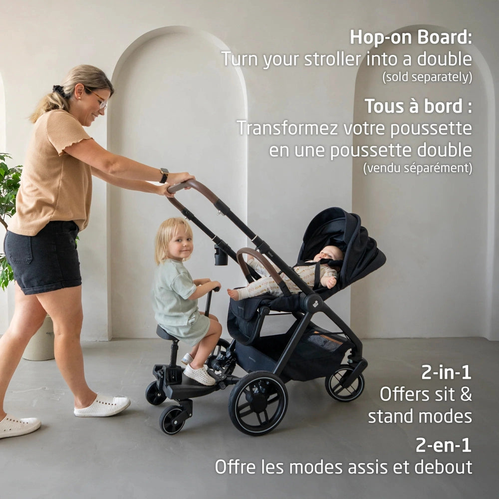 MAXI COSI Oxford Stroller & Mico Luxe+ Travel System in black; mom pushes with toddler on the ride-on board and baby in the seat.