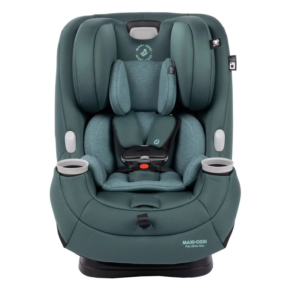 Maxi-Cosi Pria All-In-One convertible car seat in teal, with padded headrest and cup holders, showing a secure five-point harness in use.