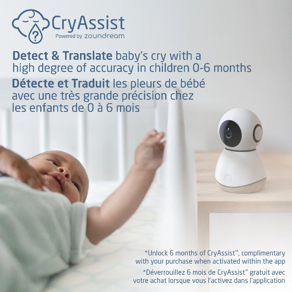 MAXI COSI See Pro 360 baby monitor in white with black lens on a bedside table near a sleeping baby