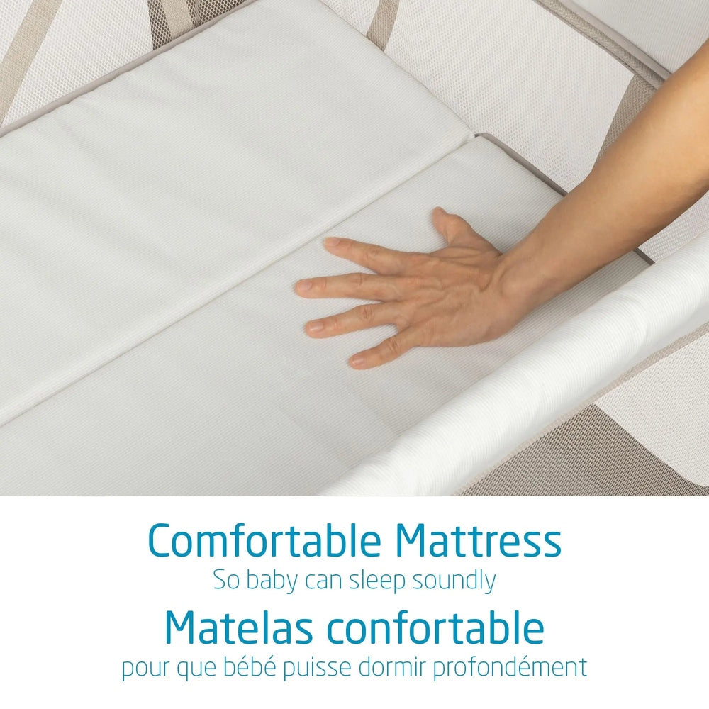 Maxi Cosi Swift Playard white mattress being pressed by a hand to show its comfortable surface.