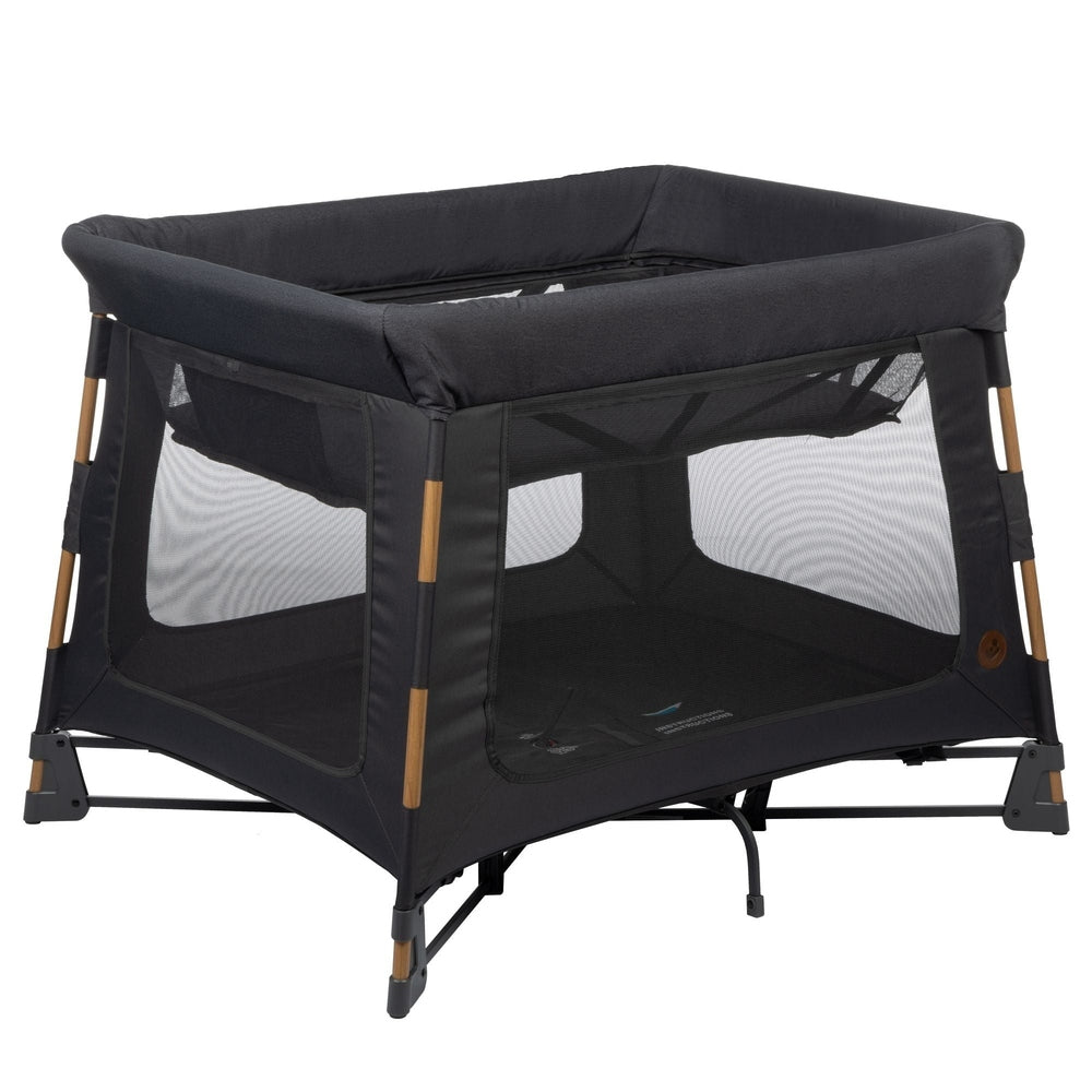 MAXI COSI Swift Playard in dark gray with mesh sides and wood-accented legs.