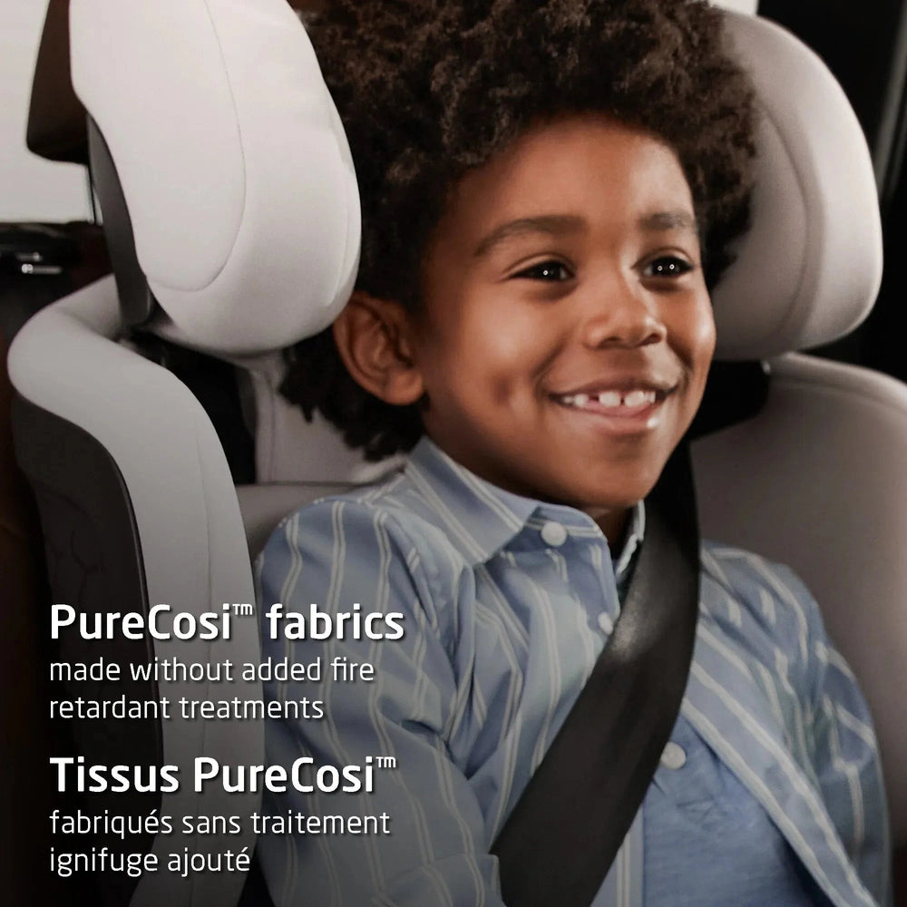 Maxi-Cosi Tanza belt-positioning booster car seat; child smiles while buckled in wearing a seat belt.