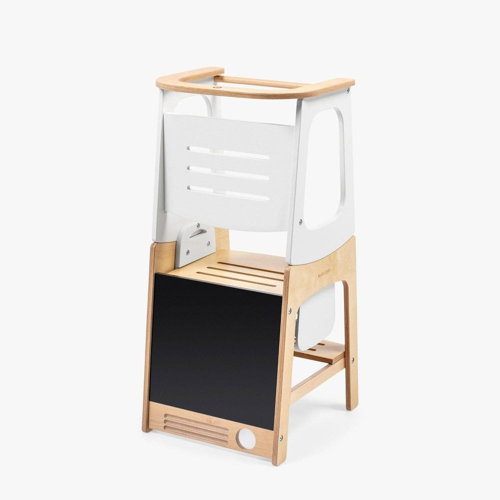 Maxi Cosi Toucan 3-in-1 learning tower with natural wood legs, white frame, and blackboard panel