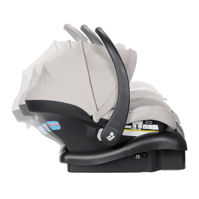 Maxi-Cosi Zelia Luxe 5-in-1 Modular Travel System stroller with beige fabric and black base, shown folded to reveal modular car seat compatibility.