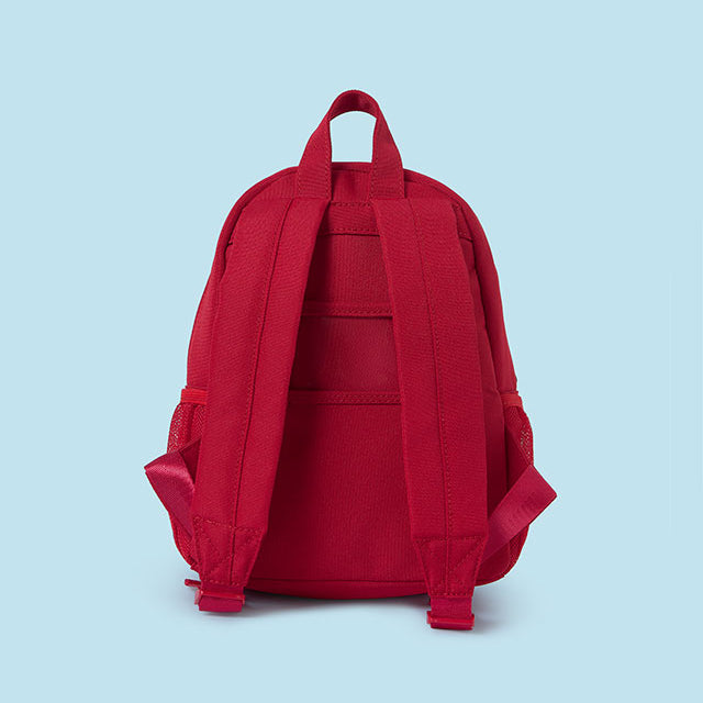 Red backpack on a light blue background