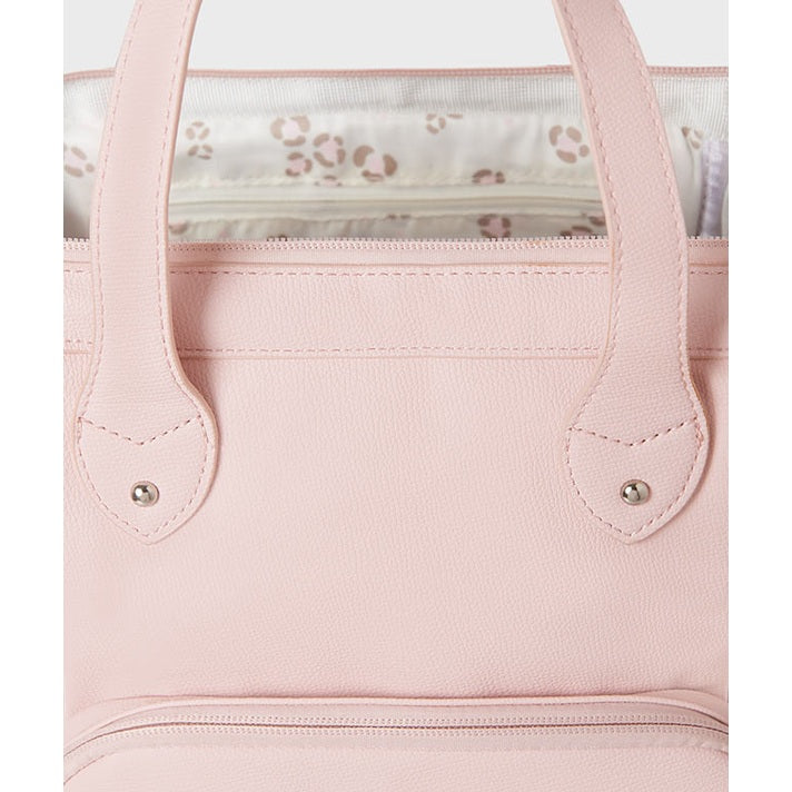 Close-up of a pink handbag with floral lining