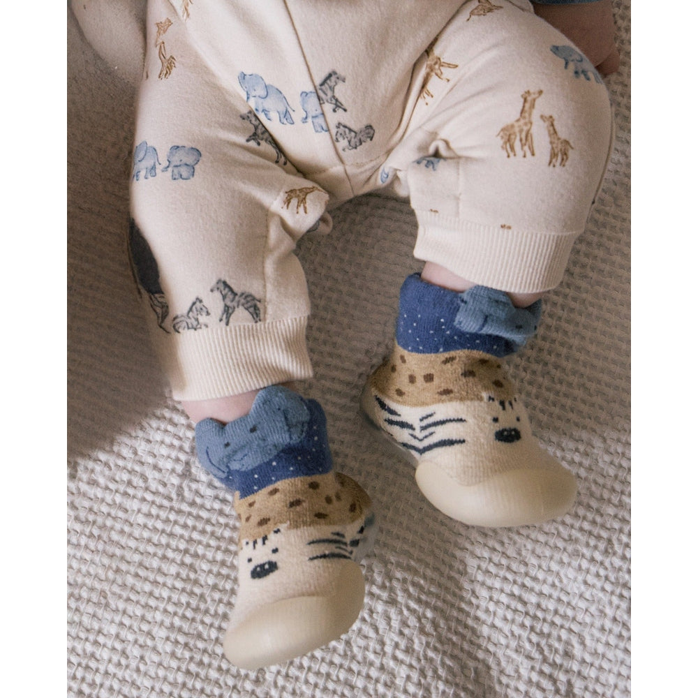 Mayoral Newborn Baby Slipper Socks-cream with tiger face and blue cuffs on a baby's feet.
