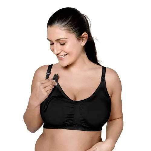 Medela 3 In 1 Nursing Bra Black, adjustable straps, shown as a mom clips the nursing strap for easy access.