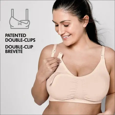 Medela 3 In 1 Nursing Bra Chai in beige; model demonstrates patented double-clips with one-handed clasping.