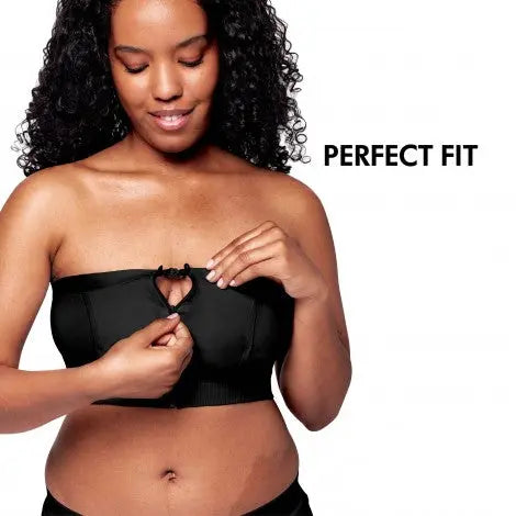 Medela Hands Free Pumping Bustier Black worn by model fastening the front clasp to show hands-free pumping design.