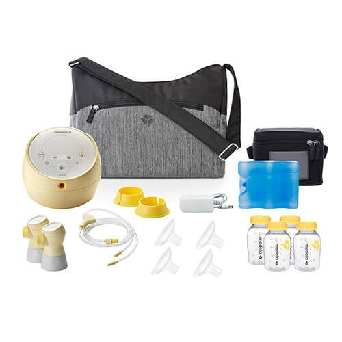 Medela Sonata Smart Breastpump kit with tote and cooler, bottles and parts laid out for on-the-go pumping.