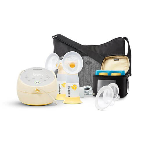 Medela Sonata Smart Breastpump kit with cream unit, white shields, bottles arranged beside a black tote.