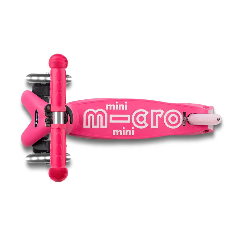 Micro Mini Deluxe Foldable LED Scooter in bright pink with MICRO logo deck and pink handle grips.