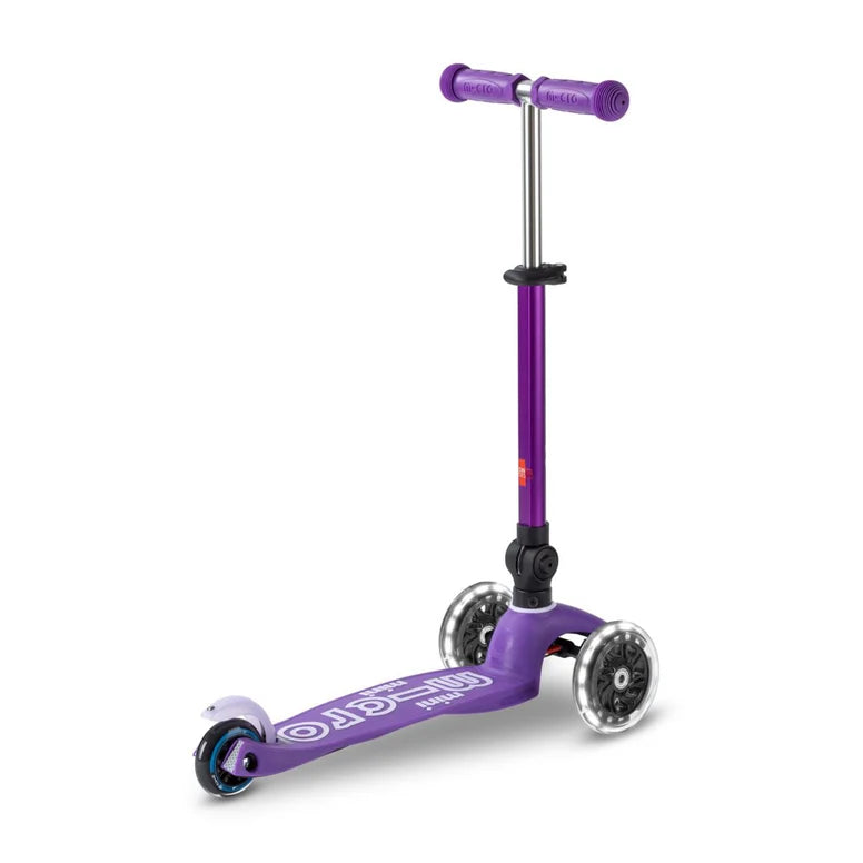Micro Mini Deluxe Foldable LED Scooter, purple three-wheel kids scooter with raised T-bar ready to ride.