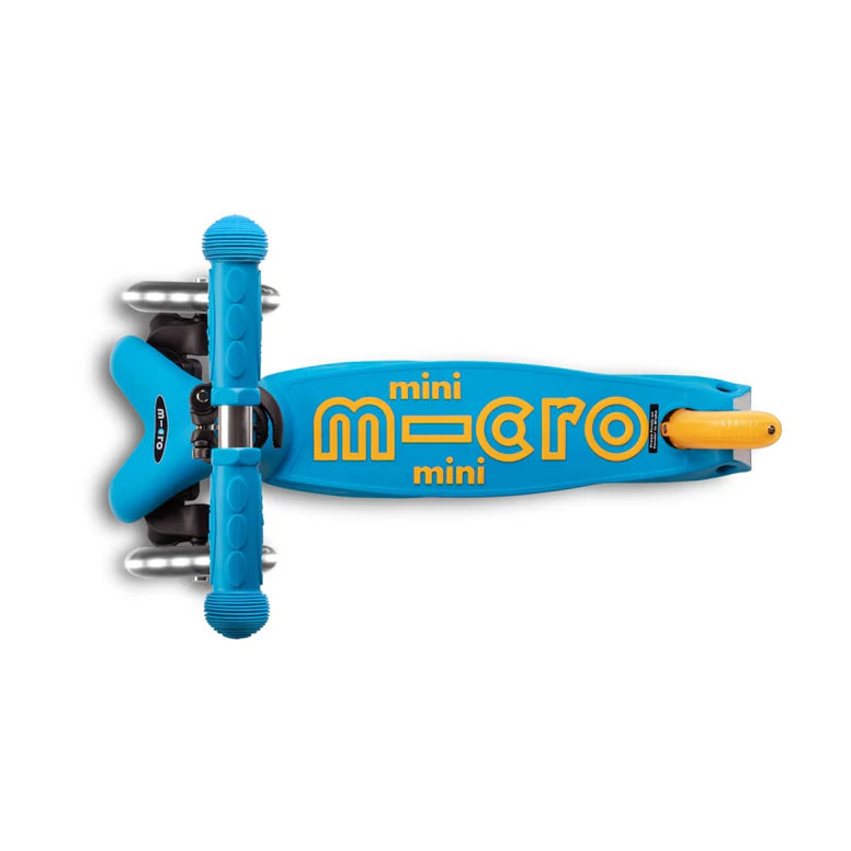 Micro Mini Deluxe Foldable LED Scooter in bright blue with yellow accents, shown folded with wheels tucked.