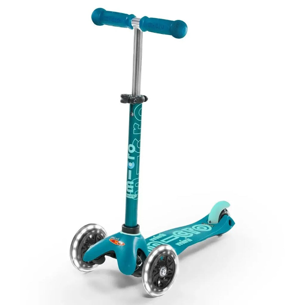 MICRO Micro Mini Deluxe Led Scooter teal three-wheel scooter with LED front wheels and low deck positioned for preschool riders