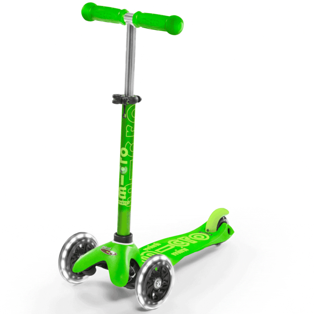 Micro Mini Deluxe LED Scooter, green three-wheel kick scooter with bright handlebars, ready to ride.