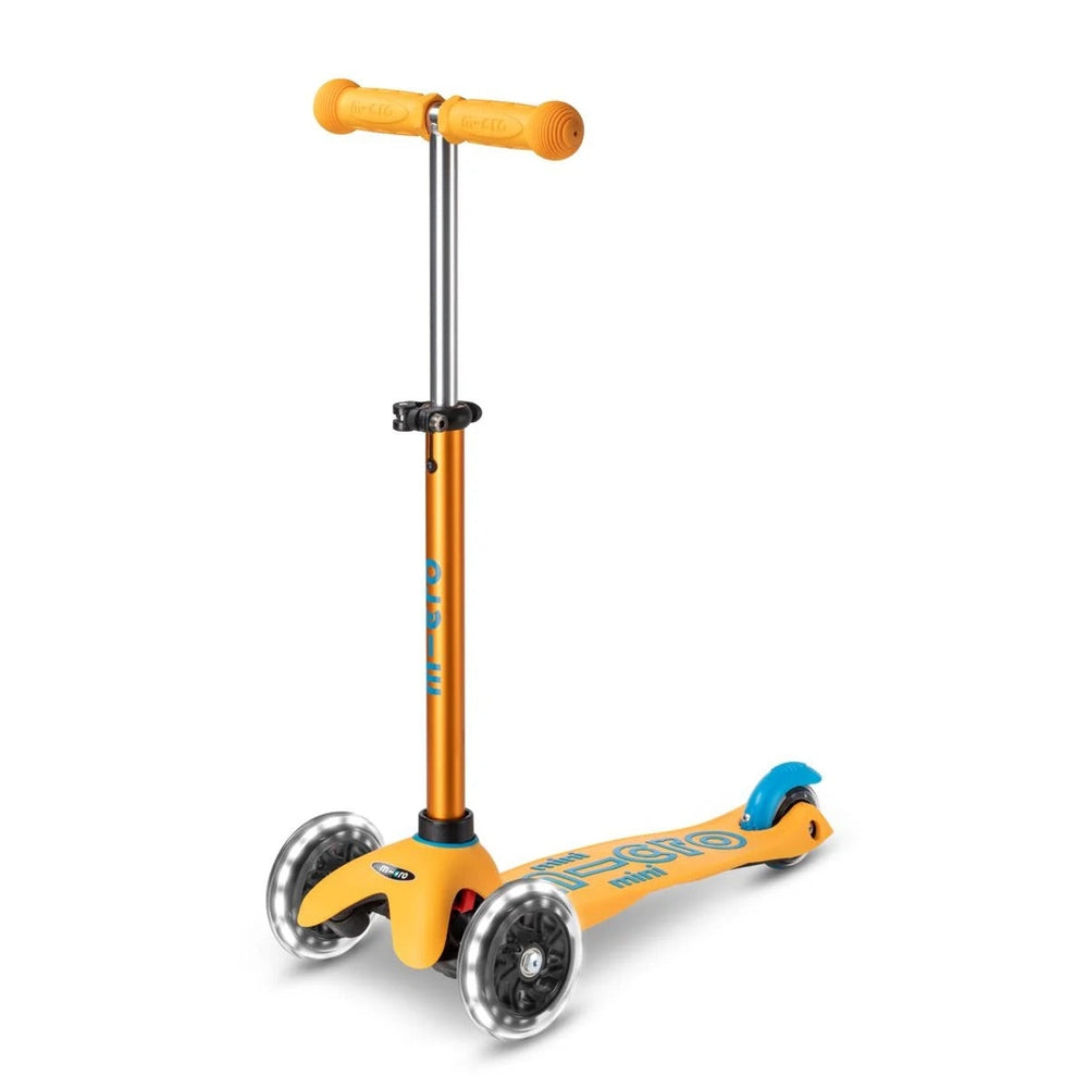 Micro Mini Deluxe LED Scooter in orange with three clear light-up wheels and adjustable T-bar handlebar