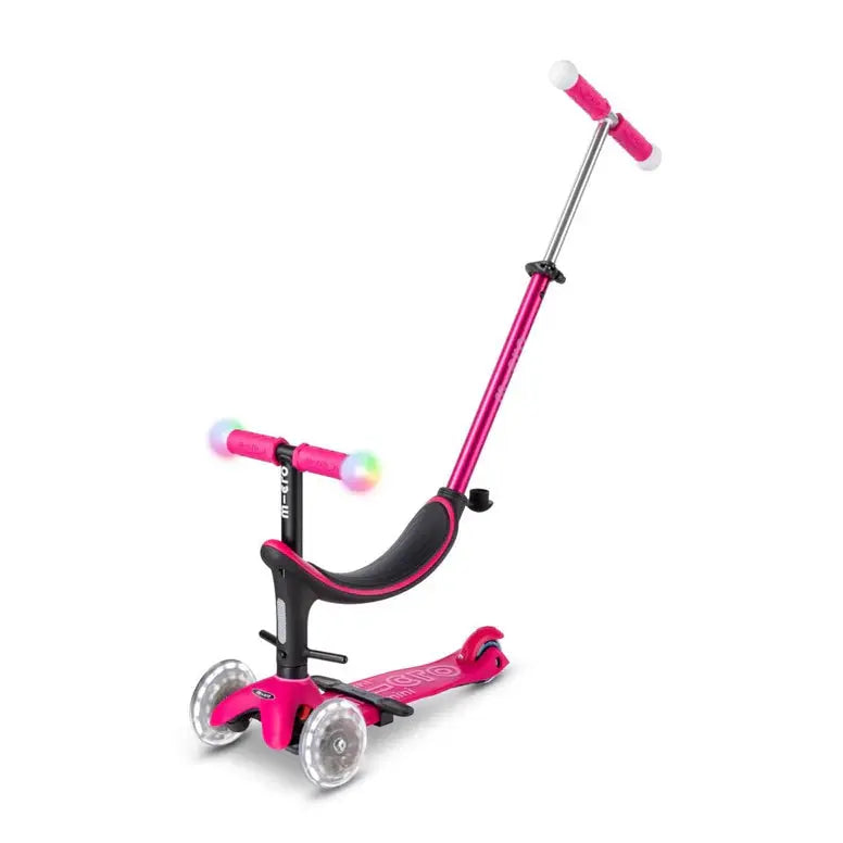 Micro Mini2Grow Deluxe LED scooter with pink frame, adjustable T-bar, and light-up three-wheel design in action.