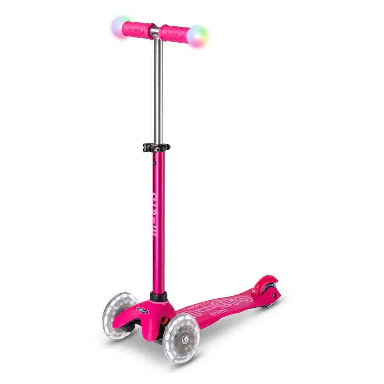 Micro Mini2Grow Deluxe LED scooter in pink with rainbow LED wheels; three-wheel kid scooter with adjustable handlebar.