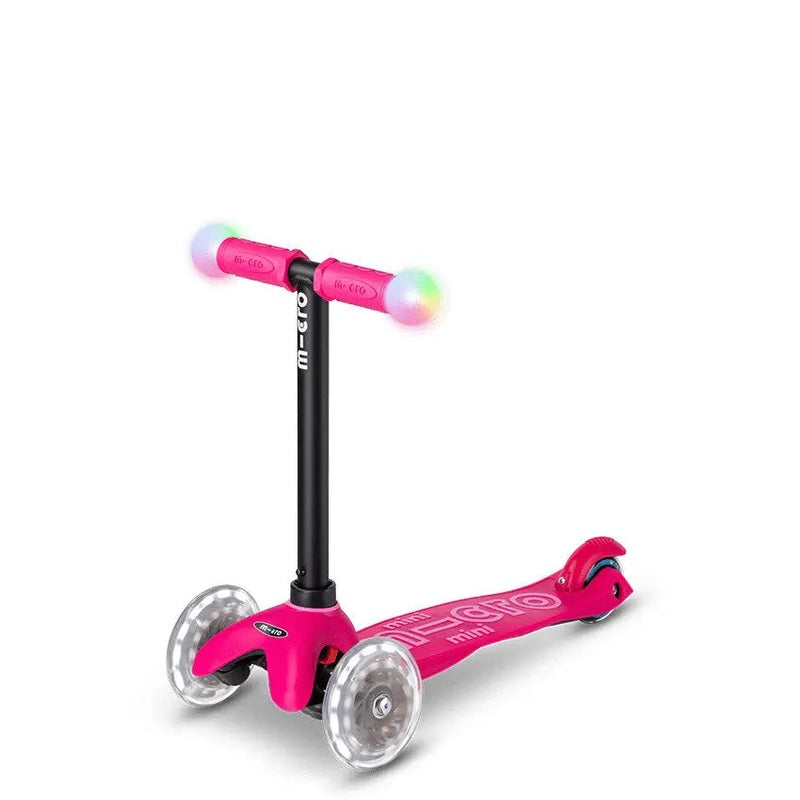Micro Mini2Grow Deluxe LED Scooter pink with rainbow LED wheels; three-wheel, stable ride.