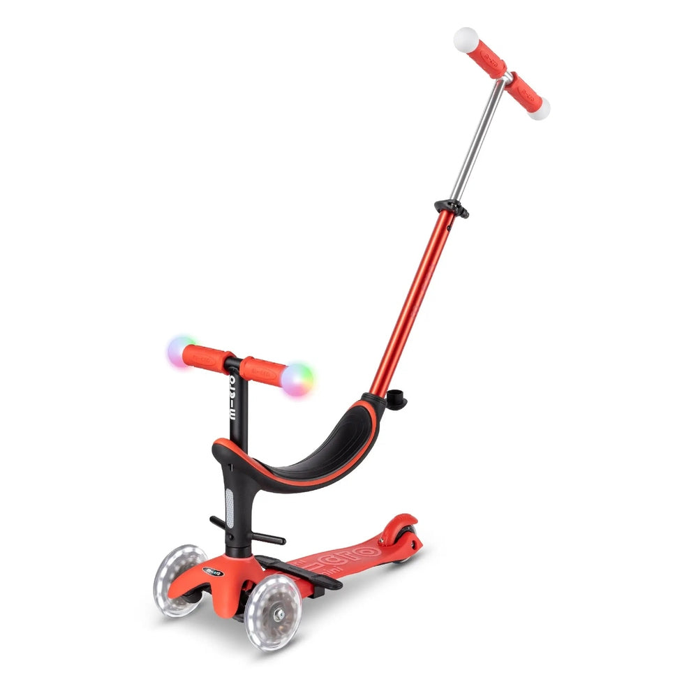Micro Mini2Grow Deluxe LED Kids Scooter with orange frame and rainbow LED wheels; adjustable T-bar handle and three-wheel design in use