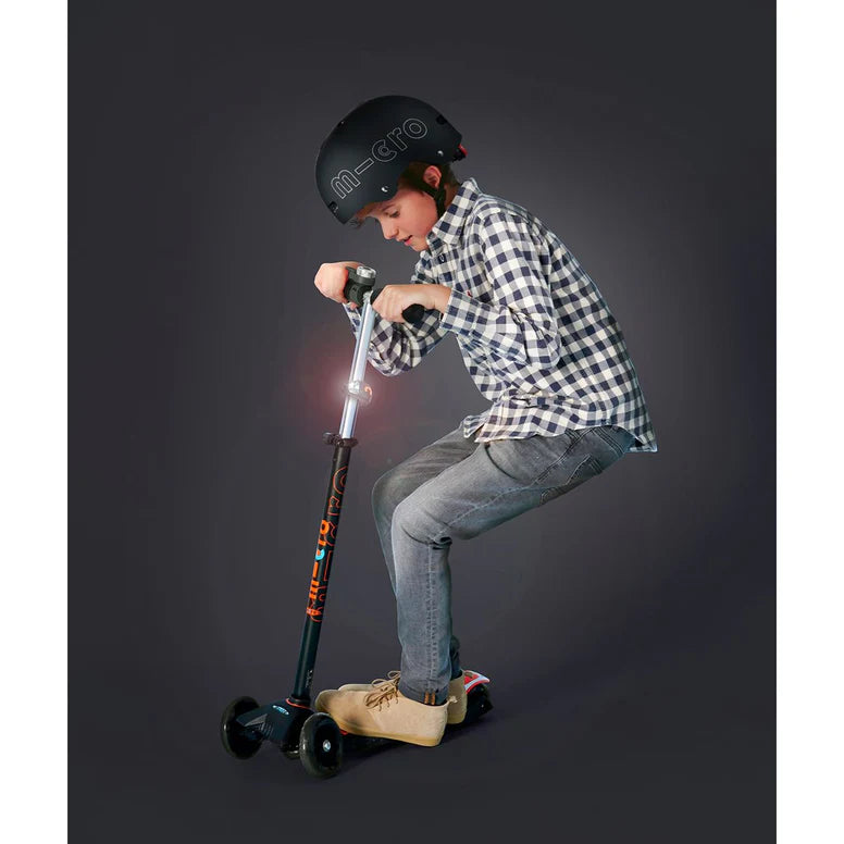 Micro Scooter Light Pink three-wheel kids' scooter with a helmeted rider, MICRO brand.