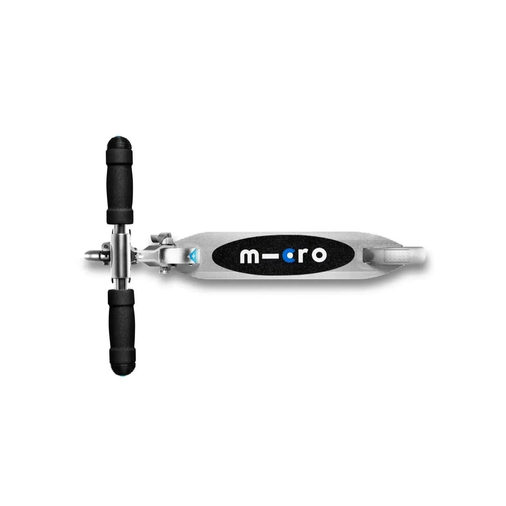 Micro Sprite LED Scooter top-down view shows a silver deck with MICRO logo and black foam grips