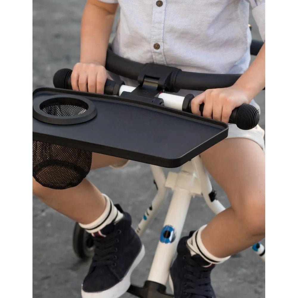 Micro Trike Table & Loop by MICRO on a white child's tricycle, black tray with mesh cup holder