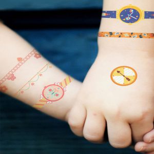 MIDEER temporary tattoos on two child wrists featuring a boy watch and bracelet designs