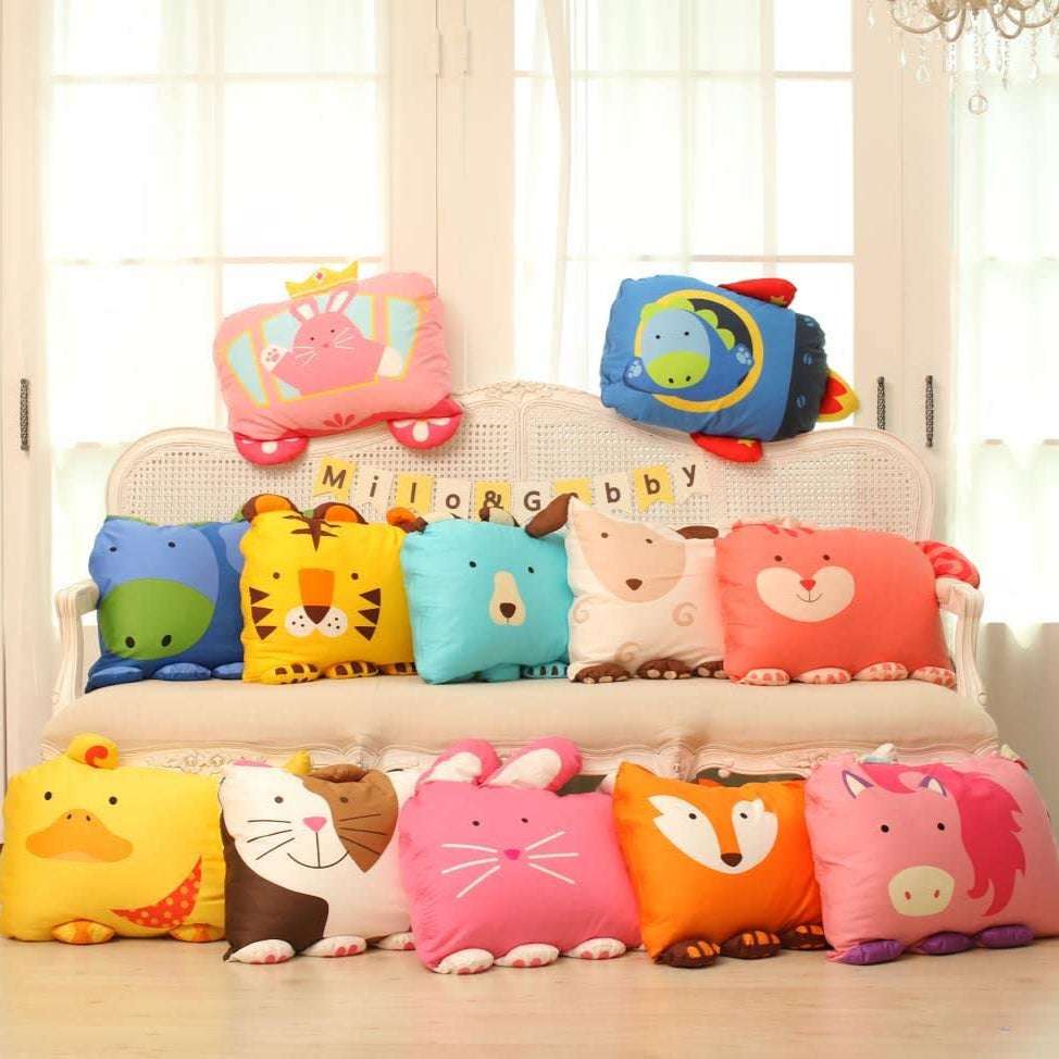 MILO & GABBY kids pillowcase set featuring colorful animal designs, 12 pieces displayed on a sofa