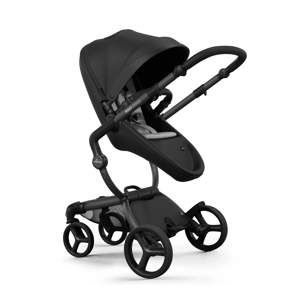 Mima Xari Max Stroller in black with large canopy and padded seat on a four-wheel chassis ready for a stroll.