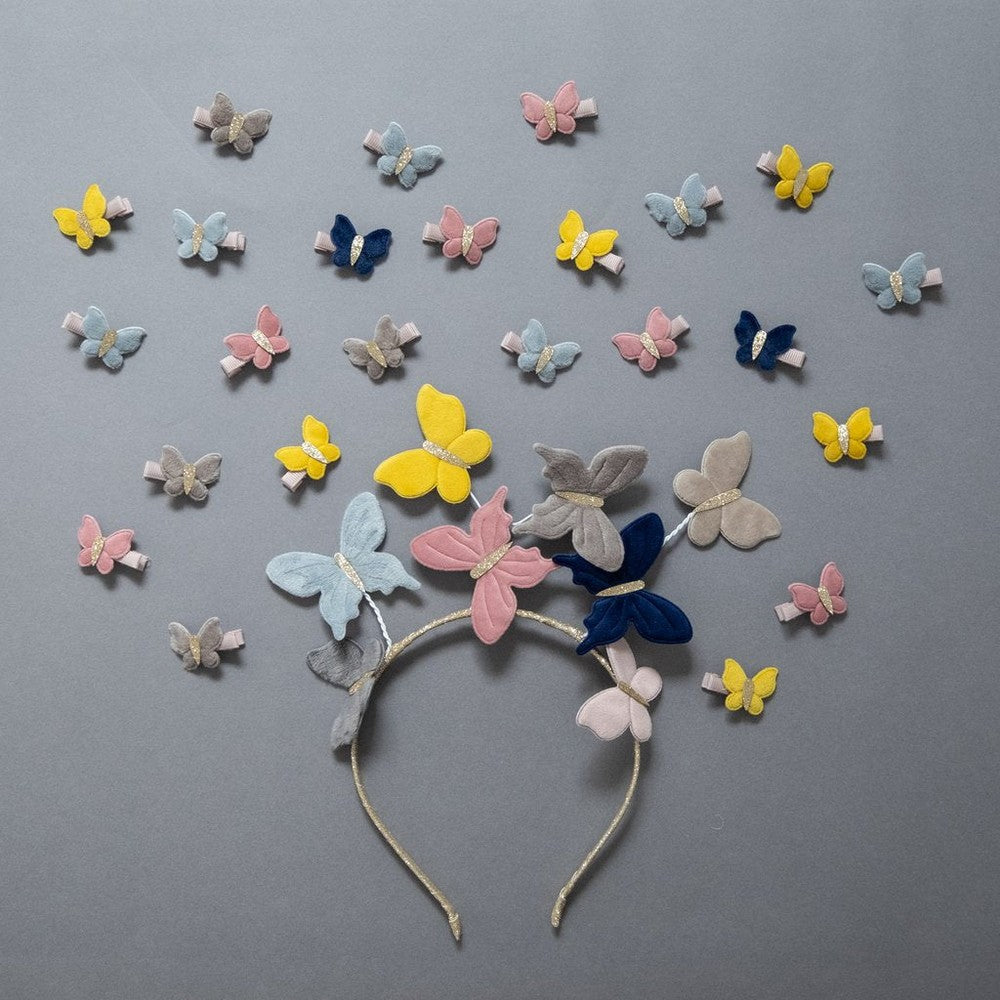 Mimi & Lula velvet butterfly headband with pastel pink, blue, yellow butterflies on a glittery band