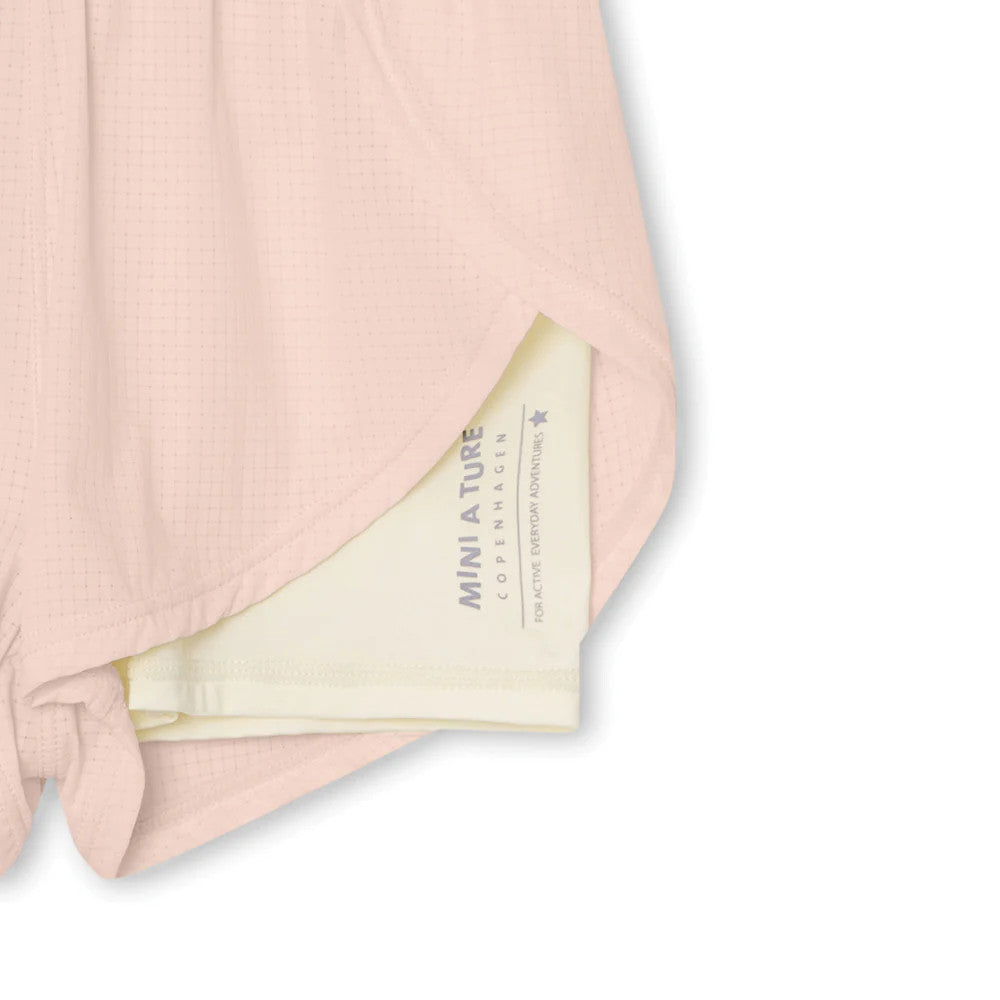 MINI A TURE Mateidie Shorts Rose Dust in soft pink breathable fabric, shown with the tied hem for adjustable fit.