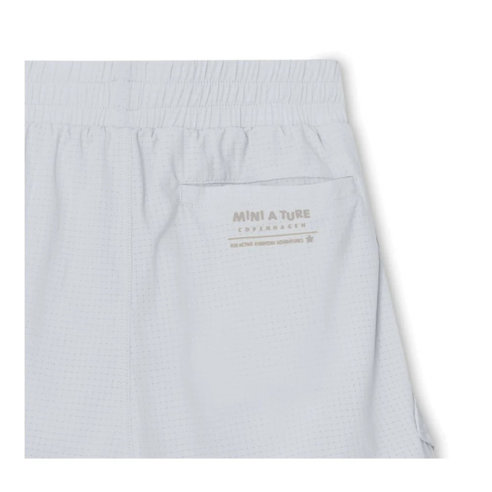 MINI A TURE Matelvart jogger shorts in pearl blue with elastic waistband and back pocket, dotted texture.