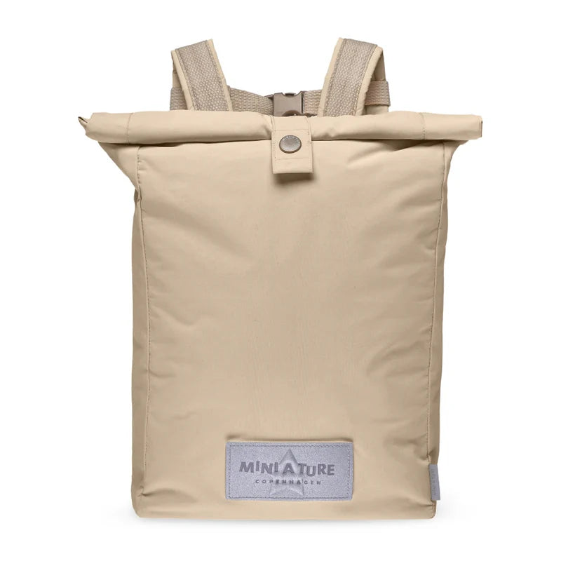 Beige roll-top backpack with a visible brand label on a white background