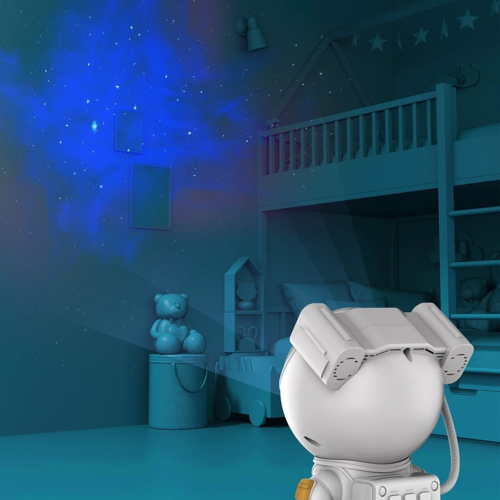 MOB Galaxy Light Projector in white projecting blue galaxy onto bedroom wall