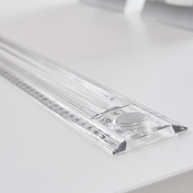 MOLL Champion height adjustable desk front up with clear ruler guide and silver knob on white desk.
